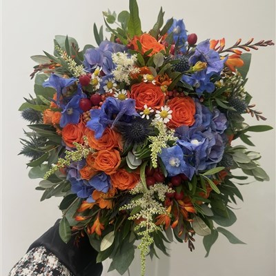 Vibrant purple and orange wedding bouquet 